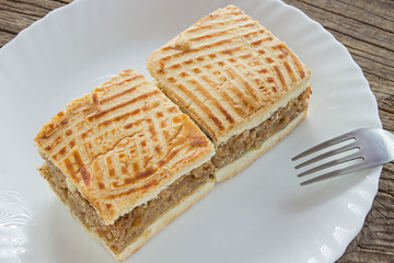 Apple pie two slices of cake on plate at wooden table