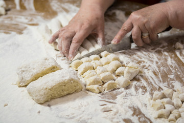 Hands kneading dough for gnocchi.