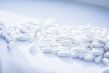 White pills heap blured background