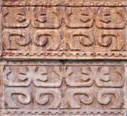 Arabesque oriental floral decorative design carved in stone wall.
