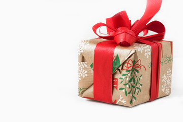 Top view of Christmas present/gift on white wooden background with copy space.