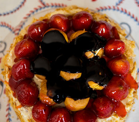Cake with strawberries and profiteroles ready to eat
