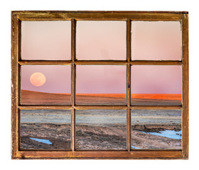 Sunset and moon rise over prairie