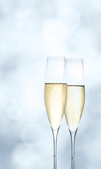 Champagne glasses on bright blue background