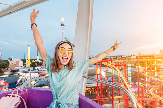 Happy And Excited Asian Girl Riding Ferris Wheel In Amusement Park