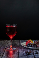 Pink wine. Wine in a glass near fruits and grapes. Traditional Georgian wine according to ancient technology. Copy space Close up and vertical orientation.