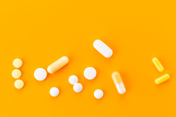various tablets and capsules with antibiotics on a colored background