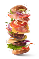 Delicious burger with flying ingredients isolated.