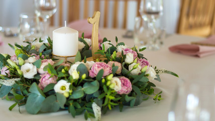 Wedding table decorations with flowers, candles and numbers