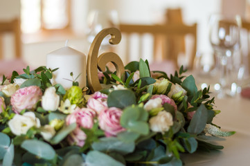 Wedding table decorations with flowers, candles and numbers