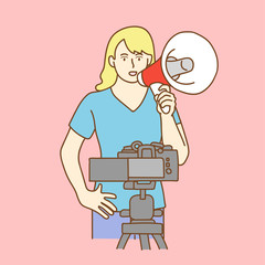 Camera recording a young female blogger talking while making a video