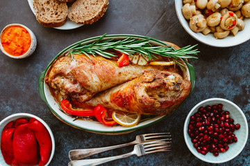 Festive dish for Thanksgiving, roasted turkey legs with vegetables on a table with snacks. Top view, flat lay.