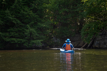 man in a kayak pausing to look at the beautiful scene with large copy space