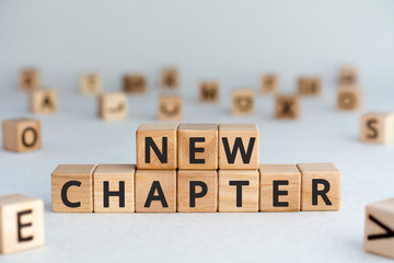 new chapter - words from wooden blocks with letters, starting new life new chapter concept, random...