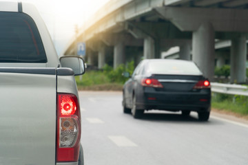 Luxury of pick up car stop on the asphalt junction by traffic light control in across. Traveling in the provinces during the bright period. Open light brake.