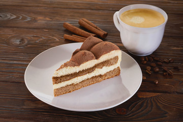 Italian Tiramisu Dessert with Cup of Coffee on Wooden Table