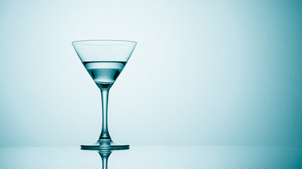 Martini glass on color background