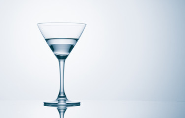 Martini glass on color background