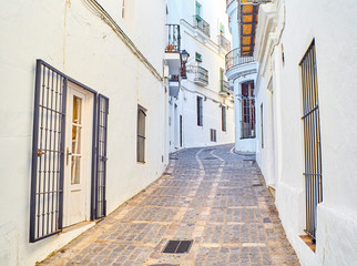 A typical street of whitewashed walls of Vejer de la Frontera downtown. View from the Jose Castrillon street. Cadiz province, Andalusia, Spain.