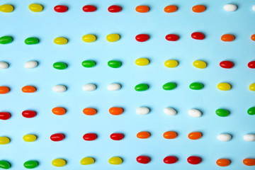 Flat lay composition with jelly beans on color background