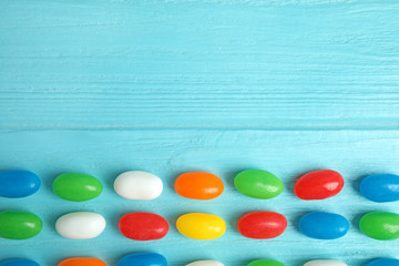 Fototapeta na wymiar Flat lay composition with jelly beans on color background. Space for text