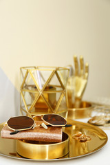Gold tray with notebook, glasses and accessories on dressing table. Space for text