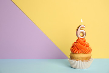 Birthday cupcake with number six candle on color background, space for text