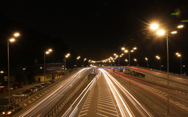 Fototapeta na wymiar Night road with illumination in modern city