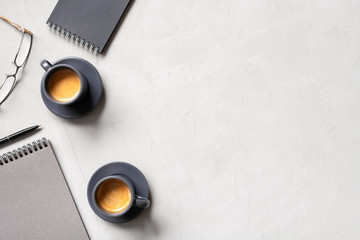 Office background with two cups of coffee espresso and open notepads