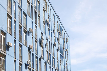 Fototapeta premium Colorful modern building with windows against sky. Urban architecture