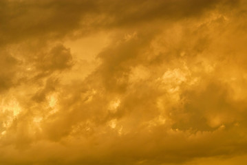 Wonderful sunset sky with golden clouds as background