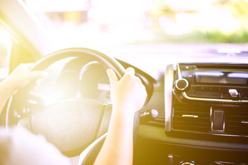 Women are driving by using the steering wheel