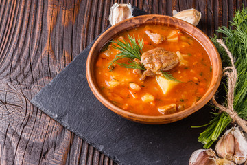 Chanahi a traditional Georgian meat stew in a bowl on stoyn board