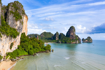 Naklejka premium Aerial view of tropical island, turquoise lagoon and islands on horizon, Krabi, Railay, Thailand.Travelling and holiday concept.