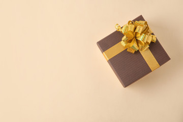 Beautiful gift box on beige background, top view. Space for text