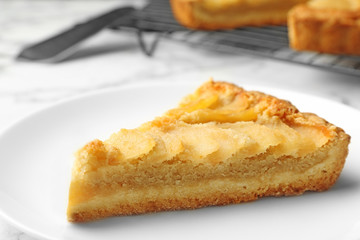 Piece of delicious sweet pear tart on table, closeup