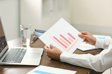 Business trainer working at table in office, closeup