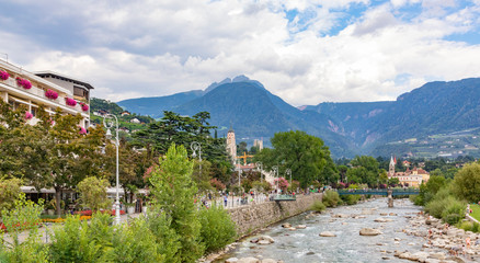 View of the promenade in Meran with view to river Passer and mountains  in Merano, South Tyrol,...