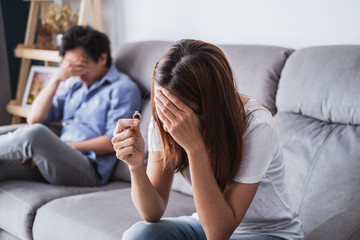 Frustrated sad wife taking off the wedding ring, Young couple breaking up divorce concept