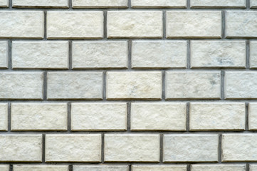 Brick wall close-up of natural light-colored stone. Textured background