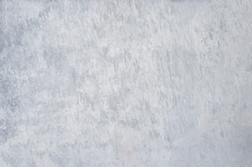 A gray concrete wall interspersed with white plaster. Background