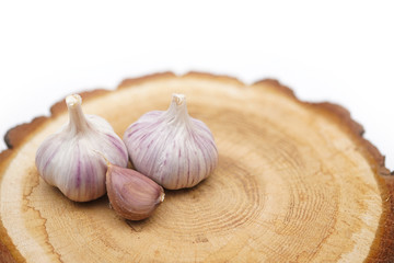 heads of fresh garlic on a wooden cut 