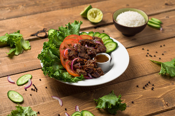  Bo Luc Lac vietnamese beef salad. Also named Lok Lak in cambodia or Shaking Beef in America. Tasty marinated sauteed beef cubes are served with fresh lettuce, tomatoes, cucumbers, onions and rice.