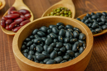 A cup of black beans  with assorted beans blurred background 