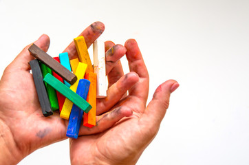 Pastel chalks in artist’s hands ready to be used.