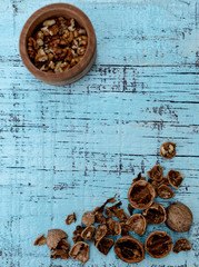 Walnuts on an old wooden background of blue color.