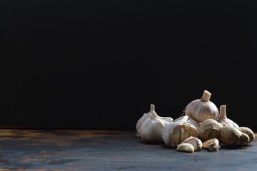 garlic in front of a black background