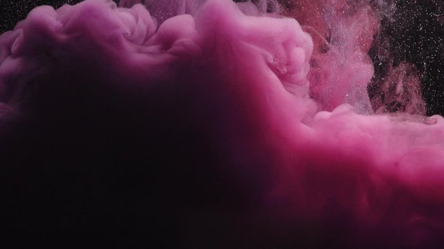 Close-up of pink purple and white colors explode under water