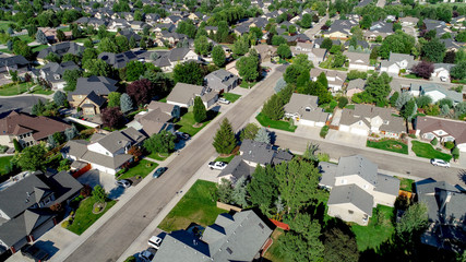 Main street leads through a subdivision with homes and trees - obrazy, fototapety, plakaty
