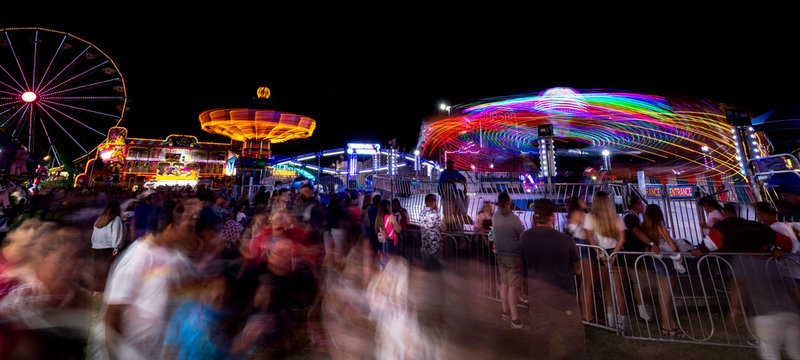 Night At The Fair With People Watching Ride Spin Around